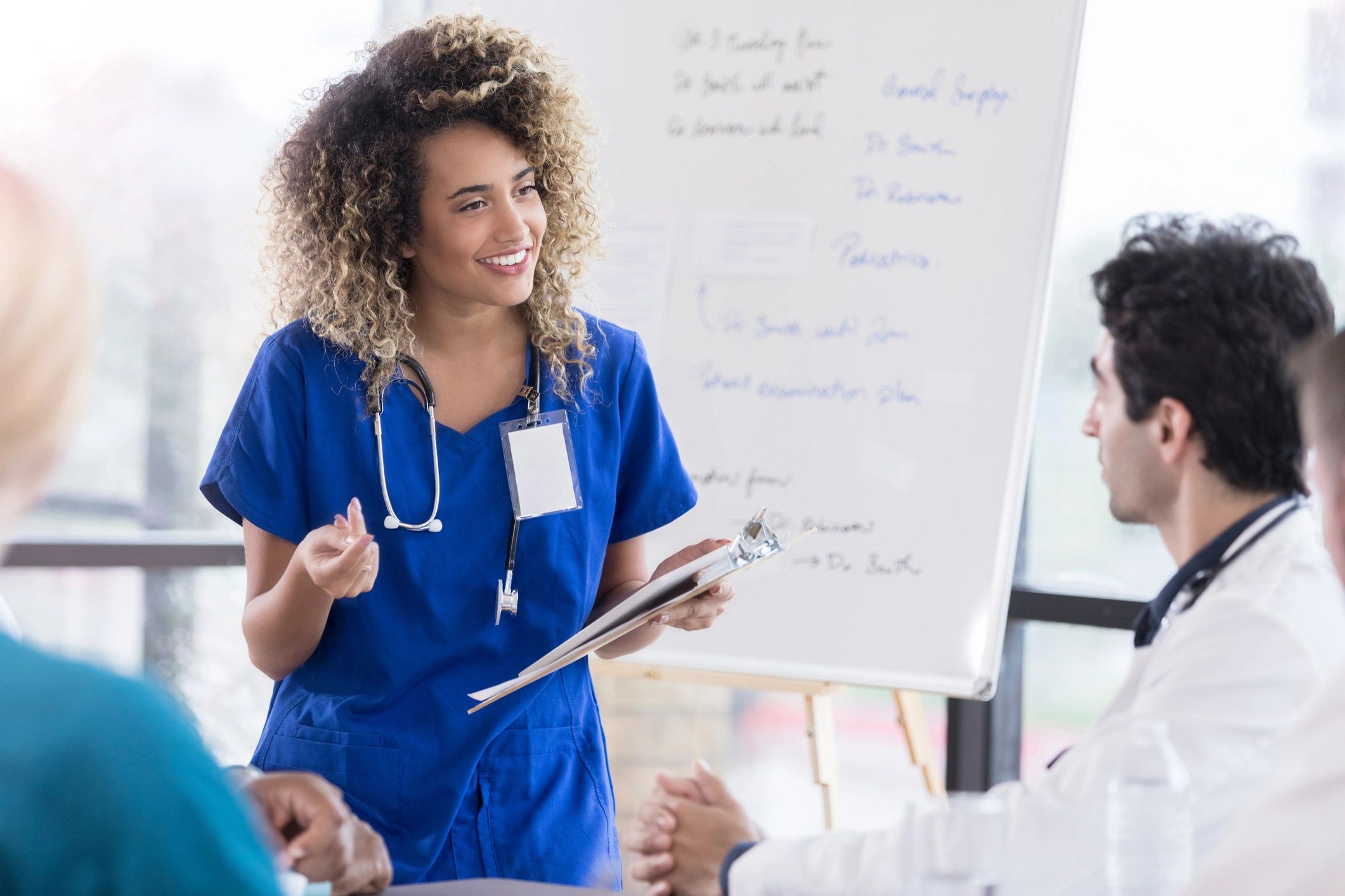 Female doctor presenting to healthcare colleagues during a meeting