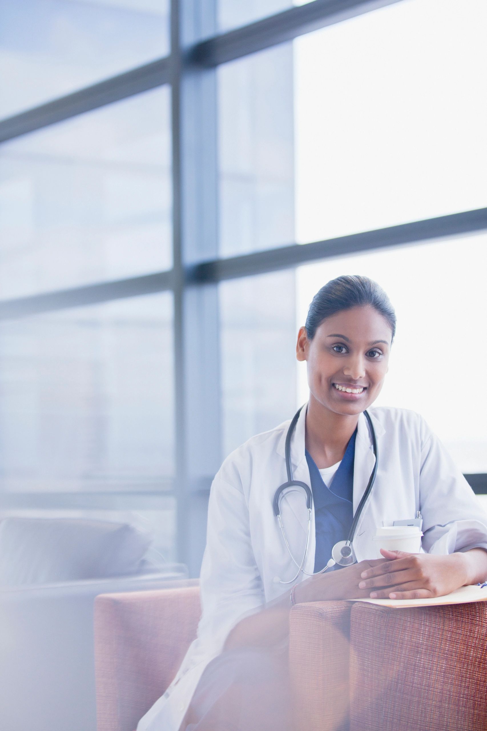 Doctor author with coffee in clinic setting