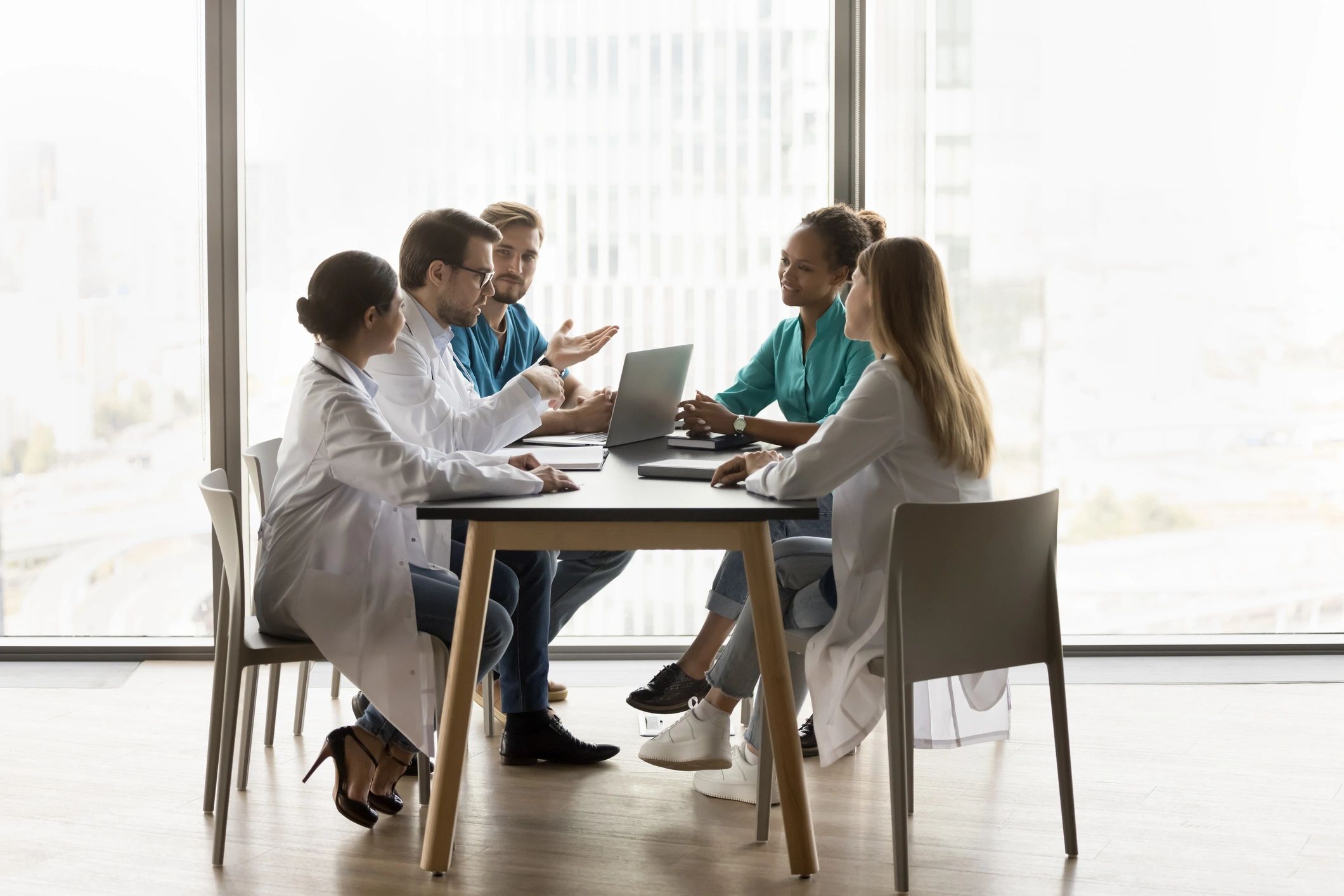 Healthcare professionals in discussion at a consultation office